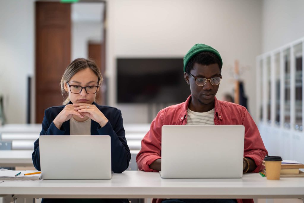 diverse multiethnic focused students studying foreign language training center classroom with laptop.jpg